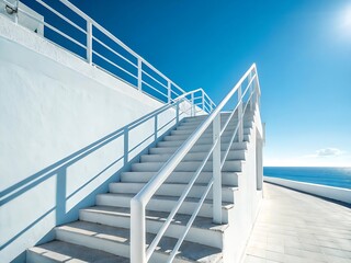 White Staircase Leading to the Ocean with Blue Sky and Sunlight