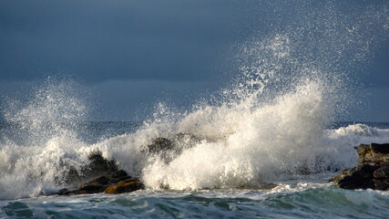 Waves breaking around rocks just off the beach in Zipolite, Mexico