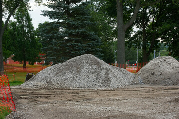 Gravel and dirt piles sit on the torn-up lawn of the Twinsburg Ohio town square in preparation for renovation and reconstruction and reconstruction work.