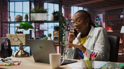 Manager in home office arguing with employee during phone call, looking at laptop. Team leader scolding worker during telephone call after finding errors in documents, camera A