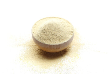 Pile ashwagandha powder in bamboo bowl, (Withania somnifera) isolated on white, side view	