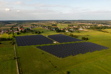 solar panels on a field,Solar panel background, aerial view of a green field with a solar power plant. An electric farm with panels for producing clean, ecological energy.