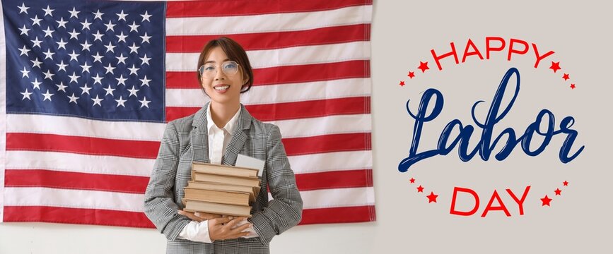 Female Asian teacher with books against USA flag. Labor Day celebration