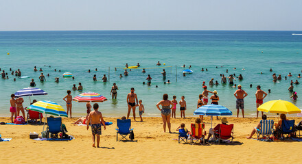 Colorful Beach Umbrellas and People Enjoying a Sunny Da