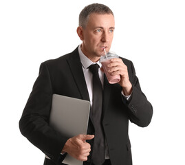 Mature businessman with laptop drinking fruit smoothie on white background