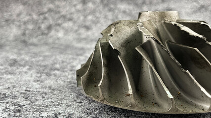 Turbocharger compressor wheel with damaged and worn blades due to friction with other object.