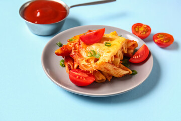 Plate of pasta with tomato sauce and cheese on blue background