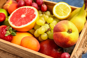 Wooden box with different fresh fruits, closeup