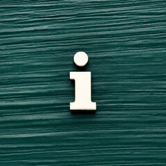 Alphabet letter i, white piece on a dark green rustic background