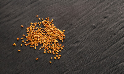Pile of natural organic fenugreek seeds - Trigonella foenum - graecum