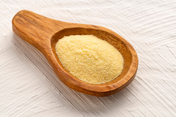 Wheat semolina in a wooden spoon - Triticum