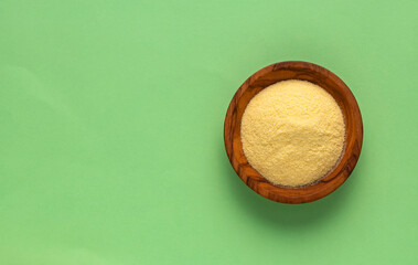 Coarse wheat semolina flour in a wooden bowl - Triticum