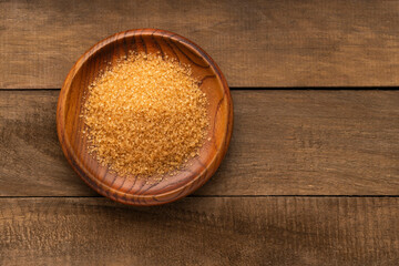 Saccharum officinarum - Organic brown sugar in a wooden bowl