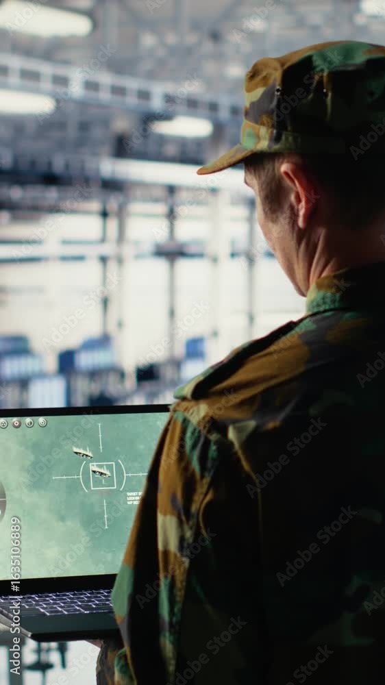 Poster vertical video military technician in data center tracking satellite coordinates using notebook soft