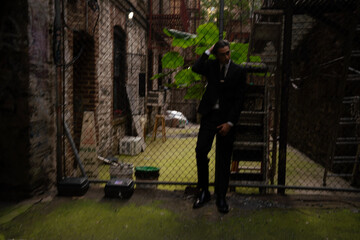 Business man walks through alley