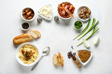 Frame made of tasty banosh and ingredients on white background