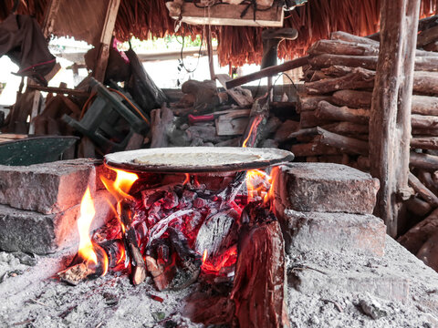 cooking tortillas on the comal over the fogon, kind of traditional mexican rural stove