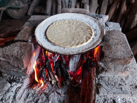 cooking tortillas on the comal over the fogon, kind of traditional mexican rural stove