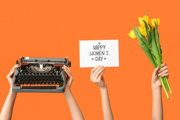 Female hands with retro typewriter, greeting card and tulip flowers for International Women's Day...