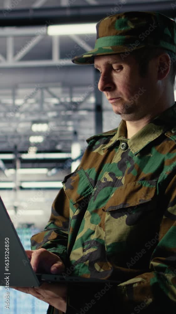 Poster vertical video army software developer in server hub uses artificial intelligence app on laptop to r