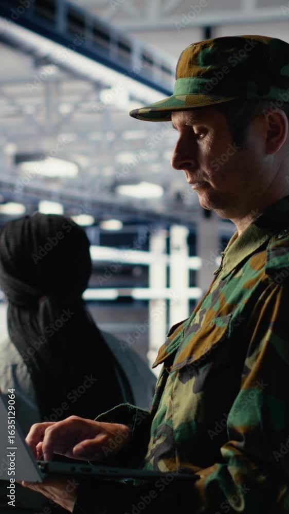 Poster vertical video military soldier and engineer in server room use ai tools to manage computer systems.