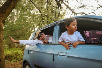 Happy kids on family car trip. Siblings hats lean out car window during road adventure. family car...
