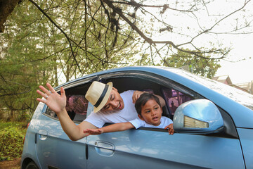 Happy family on road trip in the car. having fun with summer vacation
