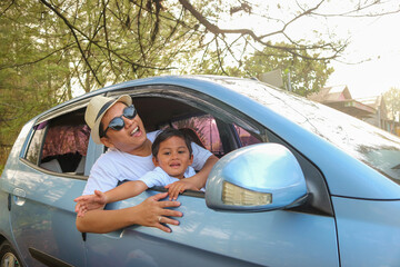 Happy family day. Asian mother father and children smiling sitting in compact white car looking out...