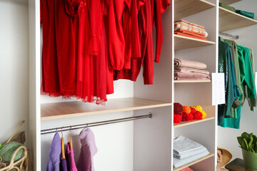 Shelves with clothes and knitting yarn in atelier