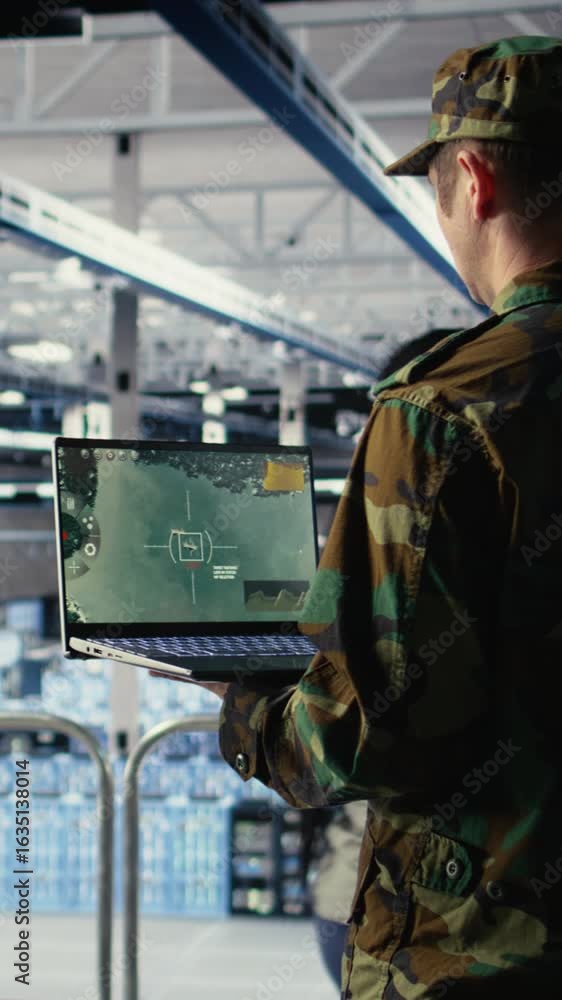 Poster vertical video military data center specialist using radar software on laptop to watch for enemy thr