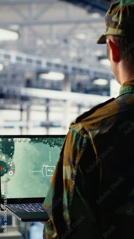 Poster vertical video military data center specialist using radar software on laptop to watch for enemy thr