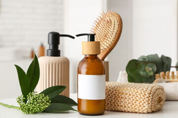 Beautiful composition with bottles of cosmetic products and bath supplies on table in bathroom,...