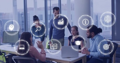 Five colleagues collaborating on business project around laptop while interface icons appearing - Powered by Adobe