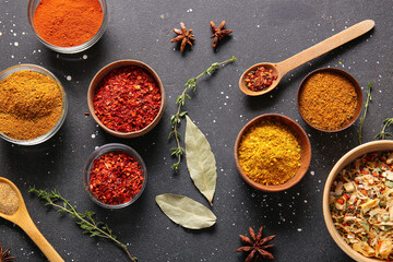 Composition with different aromatic spices on dark background