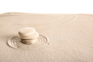Stack of stones on sand with lines against white background. Zen concept