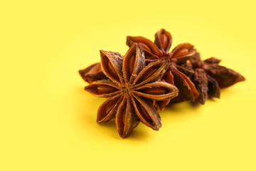 Aromatic star anise spice on yellow background