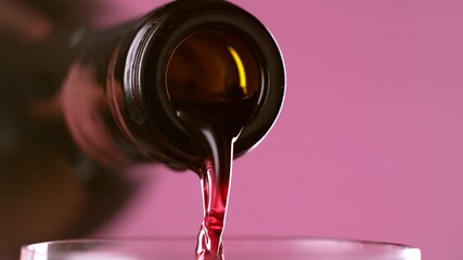 Red wine pouring from bottle in slow motion - Powered by Adobe