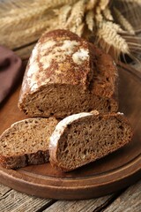 Pieces of fresh rye bread on wooden table, closeup