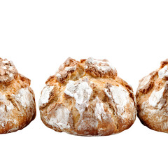 Three baked loaves of bread against black background