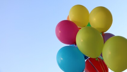 Bunch of colorful balloons under beautiful sky, low angle view. Space for text