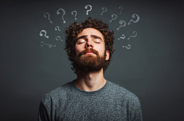 Man with beard and closed eyes stands against dark background, surrounded by question marks, conveying confusion