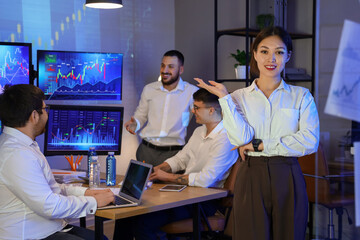 Portrait of female Asian trader in office at night