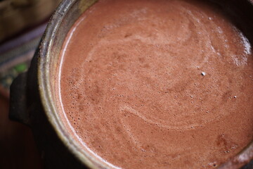 Traditional Guatemalan Mayan chocolate making with cacao beans, comal plate and metate