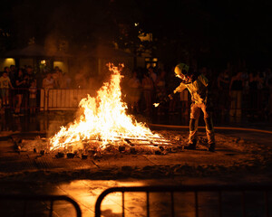 Bonfire of San Juan with Firefighter Throwing a Wish into the Fire – Traditional Celebration and...