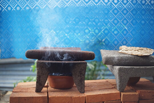 Traditional Guatemalan Mayan chocolate making with cacao beans, comal plate and metate