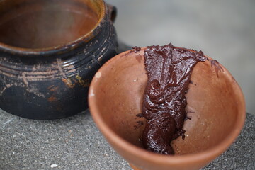 Traditional Guatemalan Mayan chocolate making with cacao beans, comal plate and metate