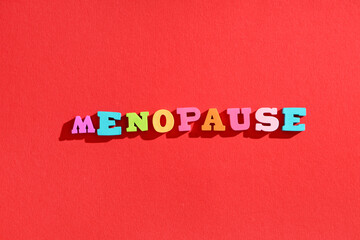 Word MENOPAUSE on red background