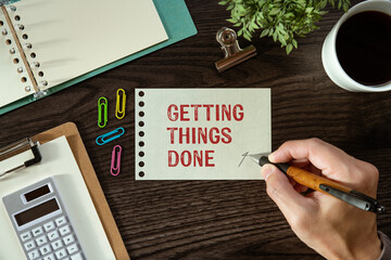 There is a piece of paper with the word Getting Things Done. It is as an eye-catching image.