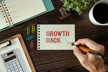 There is a piece of paper with the word Growth Hack. It is as an eye-catching image.