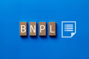 There is wood block with the word BNPL. It is an abbreviation for Buy Now, Pay Later as...